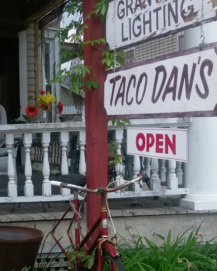 The Taco Dan's sign and the Open sign hanging from the porch post on South Prospect Street